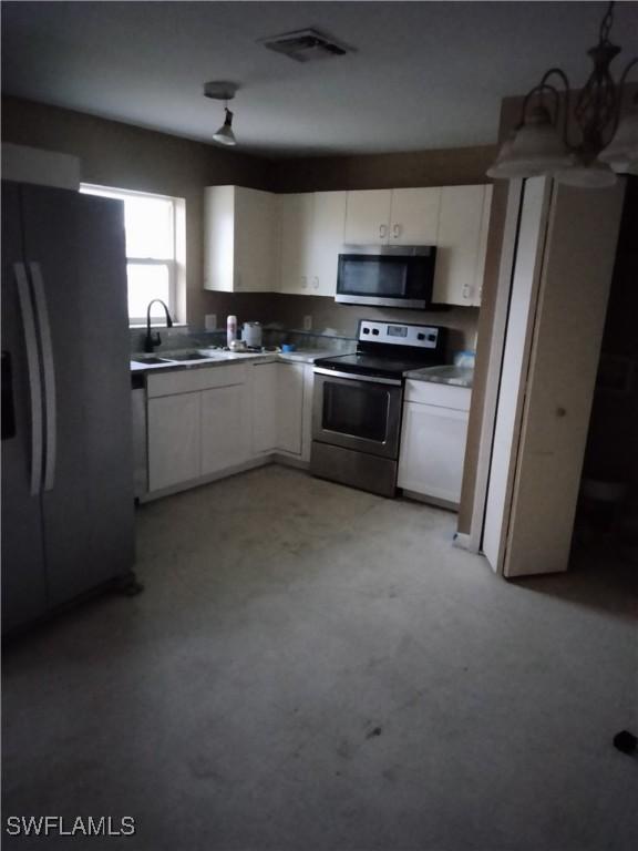 kitchen featuring white cabinets, sink, and appliances with stainless steel finishes