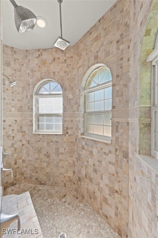 bathroom with a tile shower