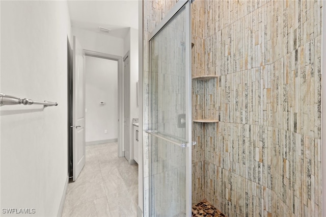 bathroom with tile patterned flooring and a shower with shower door