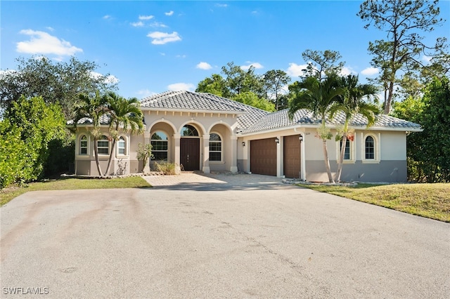 mediterranean / spanish-style home with a garage