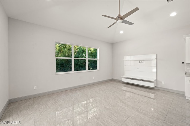 interior space featuring ceiling fan and vaulted ceiling