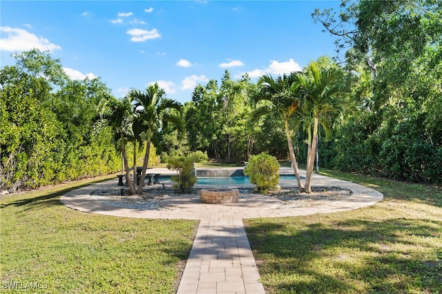 view of property's community featuring a lawn and a swimming pool