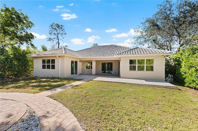 back of house featuring a yard and a patio