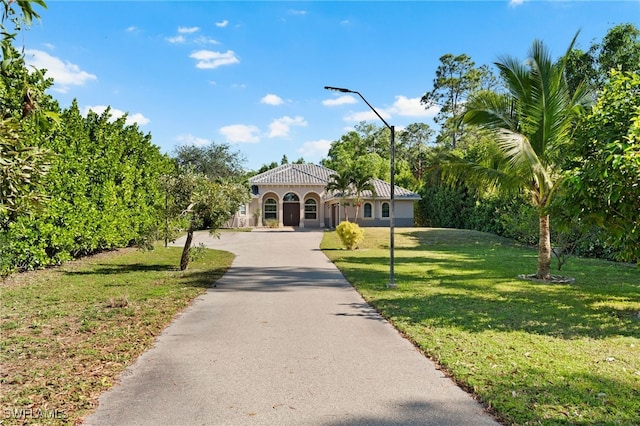 mediterranean / spanish-style house with a front lawn