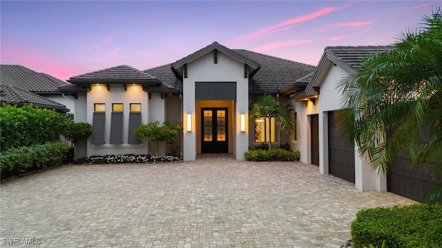 view of front of property featuring a garage and french doors