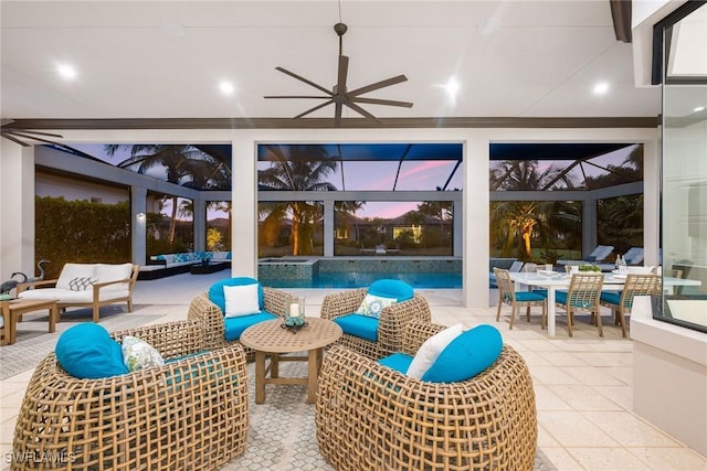 patio terrace at dusk featuring an outdoor living space, a lanai, and ceiling fan