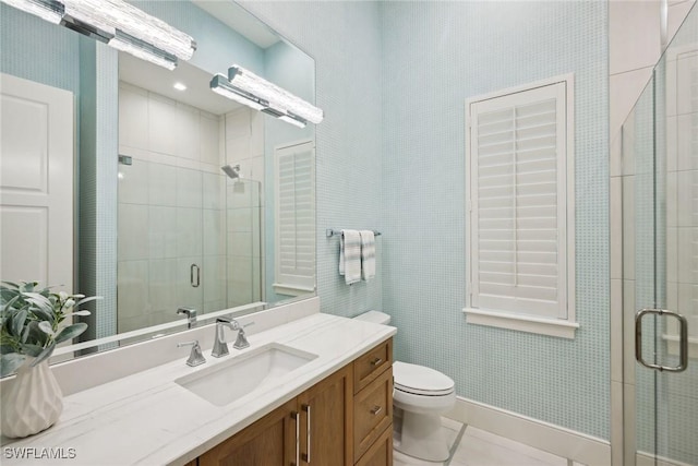 bathroom featuring vanity, toilet, a shower with door, and tile patterned flooring