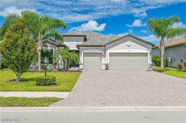 view of front of home featuring a front lawn and a garage