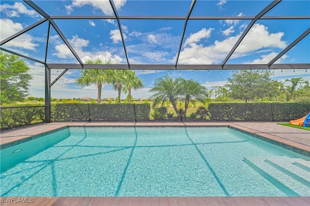 view of swimming pool with a lanai