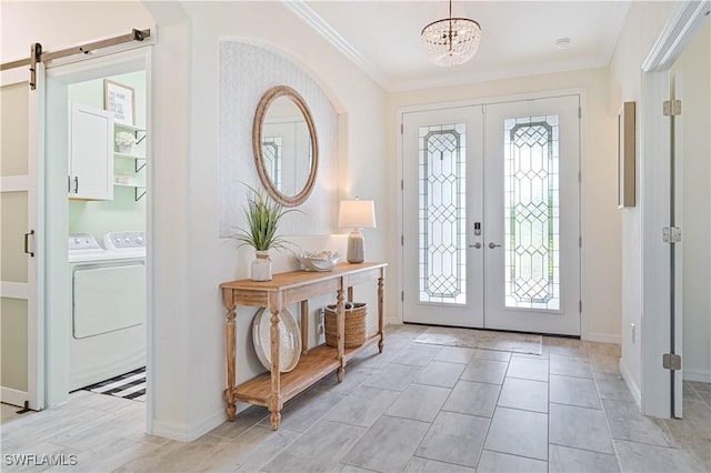 foyer featuring a notable chandelier, plenty of natural light, french doors, and a barn door