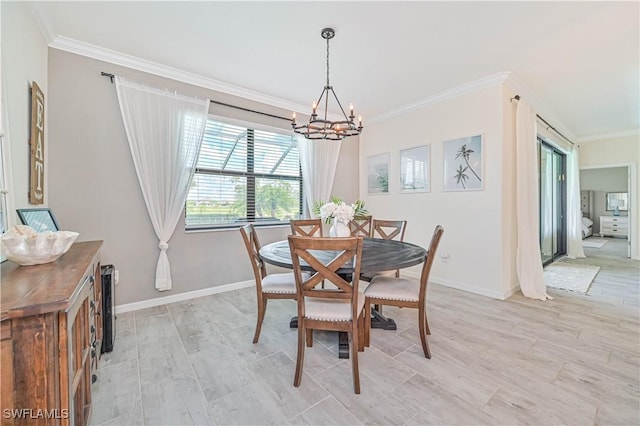 dining room featuring crown molding, an inviting chandelier, and light hardwood / wood-style flooring