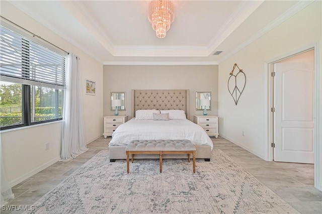 bedroom featuring an inviting chandelier, crown molding, and a raised ceiling