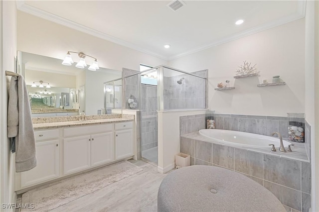 bathroom with vanity, ornamental molding, and separate shower and tub