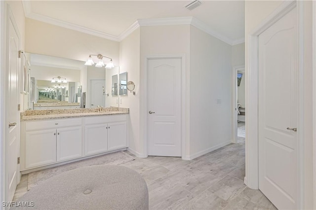 bathroom with vanity and crown molding