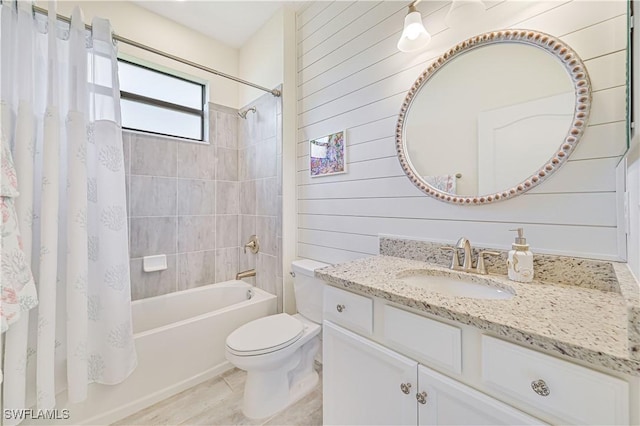 full bathroom featuring shower / bath combo, vanity, tile patterned floors, toilet, and wood walls