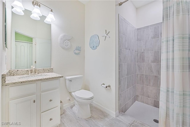 bathroom featuring walk in shower, vanity, and toilet