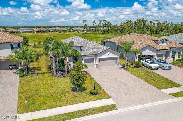 view of front of property with a garage and a front lawn