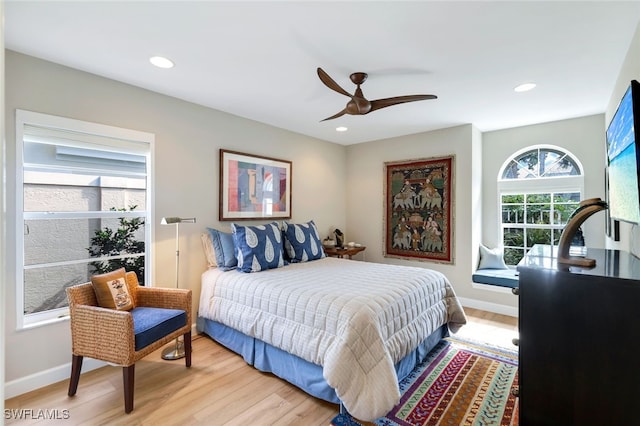 bedroom with ceiling fan and light wood-type flooring