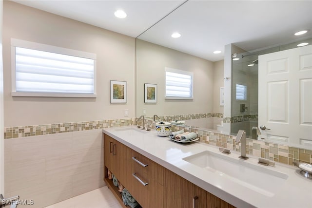 bathroom featuring tile patterned floors, vanity, walk in shower, and tile walls