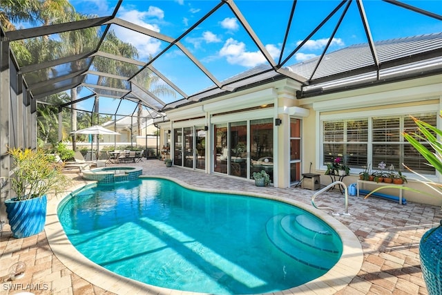 view of swimming pool featuring a lanai, a patio area, and an in ground hot tub