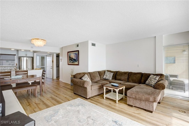 living room with wood-type flooring and a textured ceiling