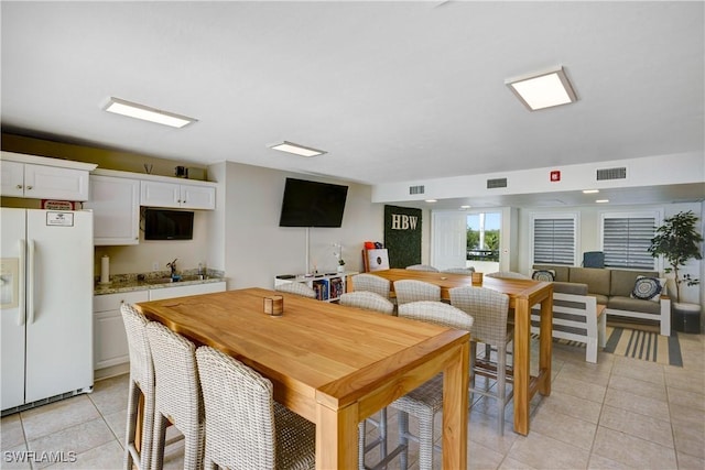 tiled dining room with sink