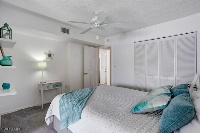 bedroom featuring carpet, a textured ceiling, a closet, and ceiling fan