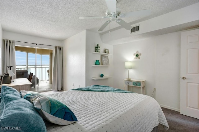 bedroom featuring carpet, ceiling fan, access to exterior, and a textured ceiling