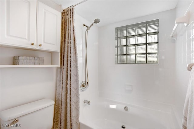 bathroom featuring shower / bath combo with shower curtain and toilet