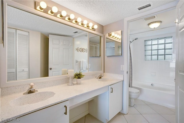 full bathroom featuring tile patterned floors, vanity, a textured ceiling, washtub / shower combination, and toilet