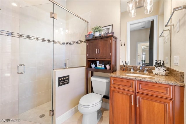 bathroom featuring toilet, tile patterned flooring, an enclosed shower, and vanity