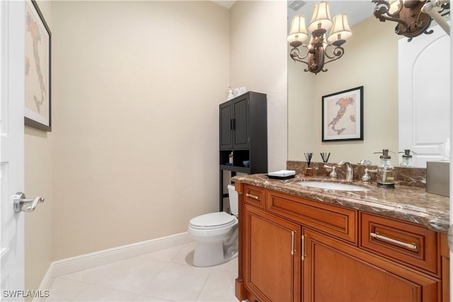 bathroom featuring vanity, toilet, tile patterned floors, and an inviting chandelier