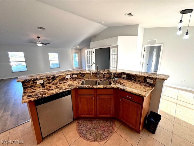 kitchen with french doors, ceiling fan, a kitchen island with sink, sink, and dishwasher