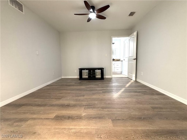 unfurnished living room featuring dark hardwood / wood-style floors and ceiling fan