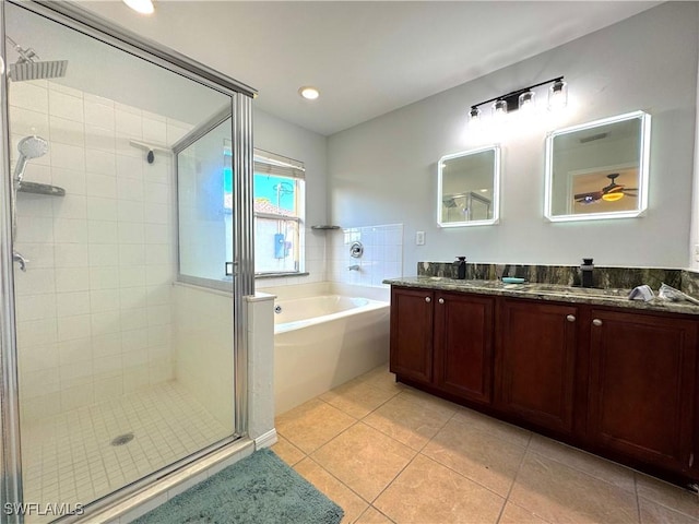 bathroom with tile patterned flooring, vanity, and plus walk in shower