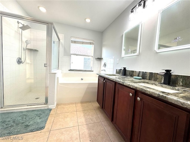 bathroom with plus walk in shower, tile patterned flooring, and vanity