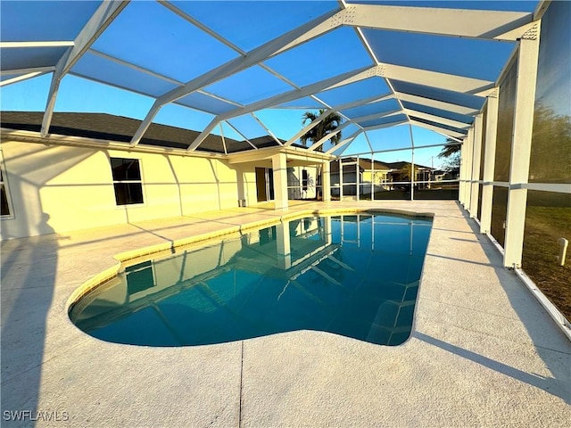 view of pool featuring a patio and glass enclosure