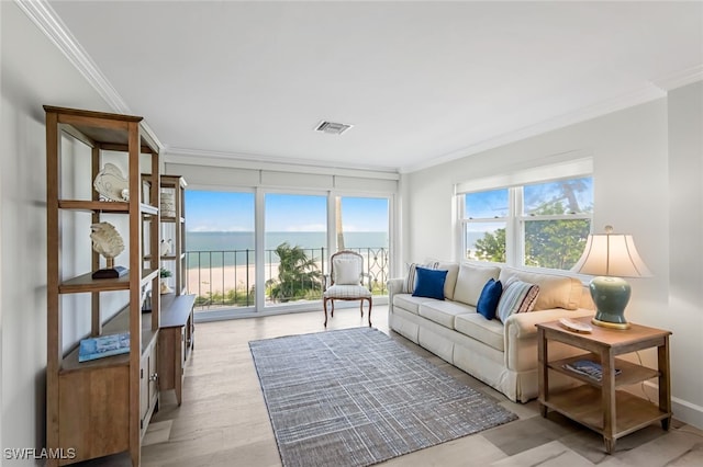 sunroom featuring a water view