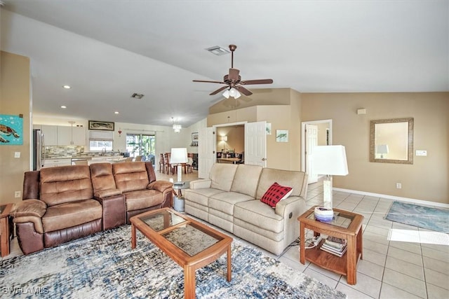 tiled living room with ceiling fan and vaulted ceiling