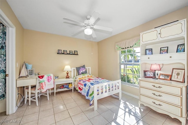 tiled bedroom featuring ceiling fan