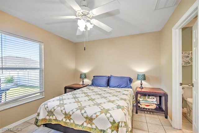 tiled bedroom with multiple windows and ceiling fan