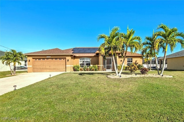 ranch-style house with solar panels, a garage, and a front yard