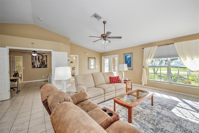 living room featuring ceiling fan, light tile patterned flooring, and lofted ceiling