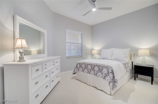 bedroom with baseboards, a ceiling fan, and light colored carpet