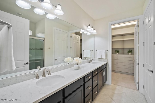 bathroom featuring tile patterned flooring, vanity, and an enclosed shower