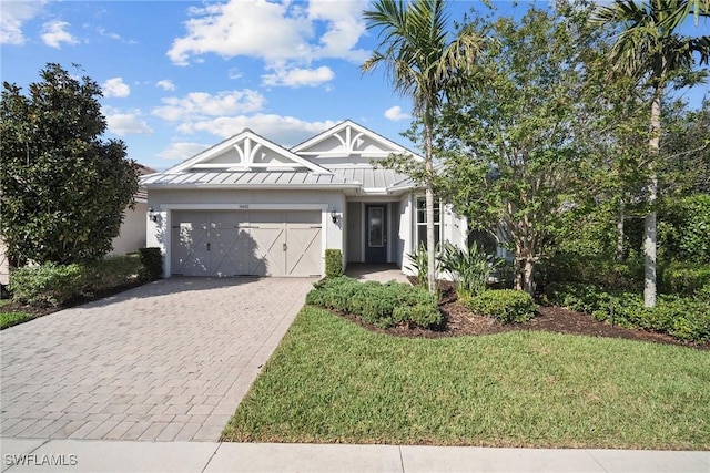 view of front of home with a front yard and a garage