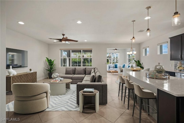 living room with ceiling fan and light tile patterned floors