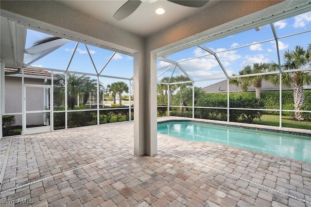 view of pool featuring ceiling fan, a lanai, and a patio