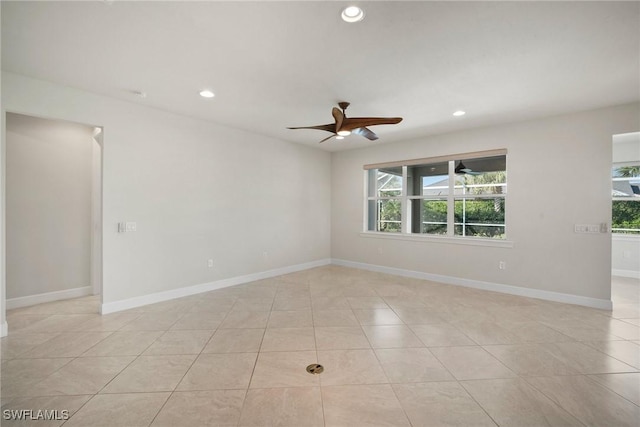 tiled empty room with ceiling fan