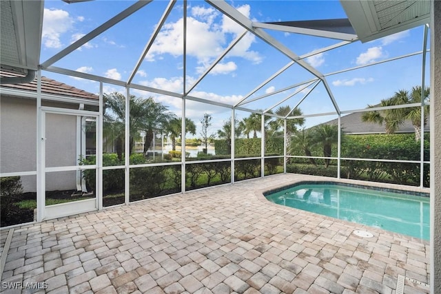 view of swimming pool featuring a lanai and a patio area